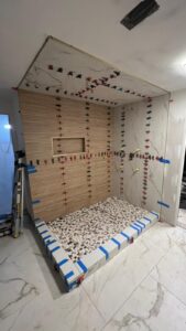 Bathroom remodeling in progress with wall tile installation by Cornerstone Flooring in Orlando