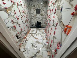 Shower tile installation in progress during bathroom remodeling by Cornerstone Flooring in Winter Park
