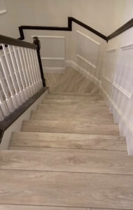 Windermere staircase remodel with new wood treads and black-and-white railing installation